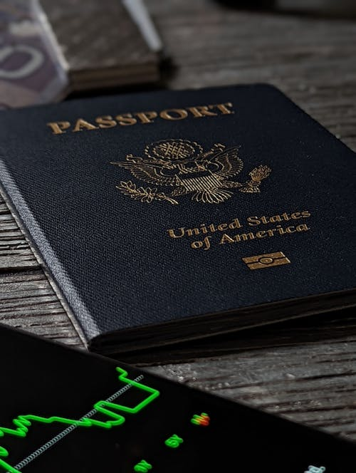 US passport is placed on a table with a graph placed below.