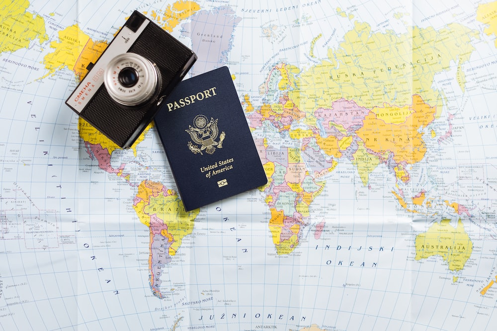 a passport lying on an Atlas