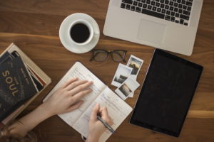 a person writing something in a journal