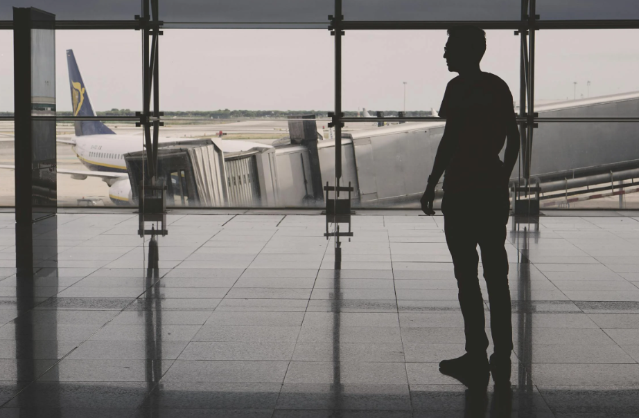 A person standing at an airport. 