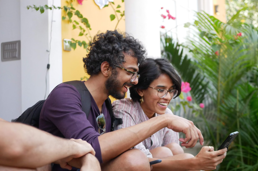 A couple using a phone while traveling.