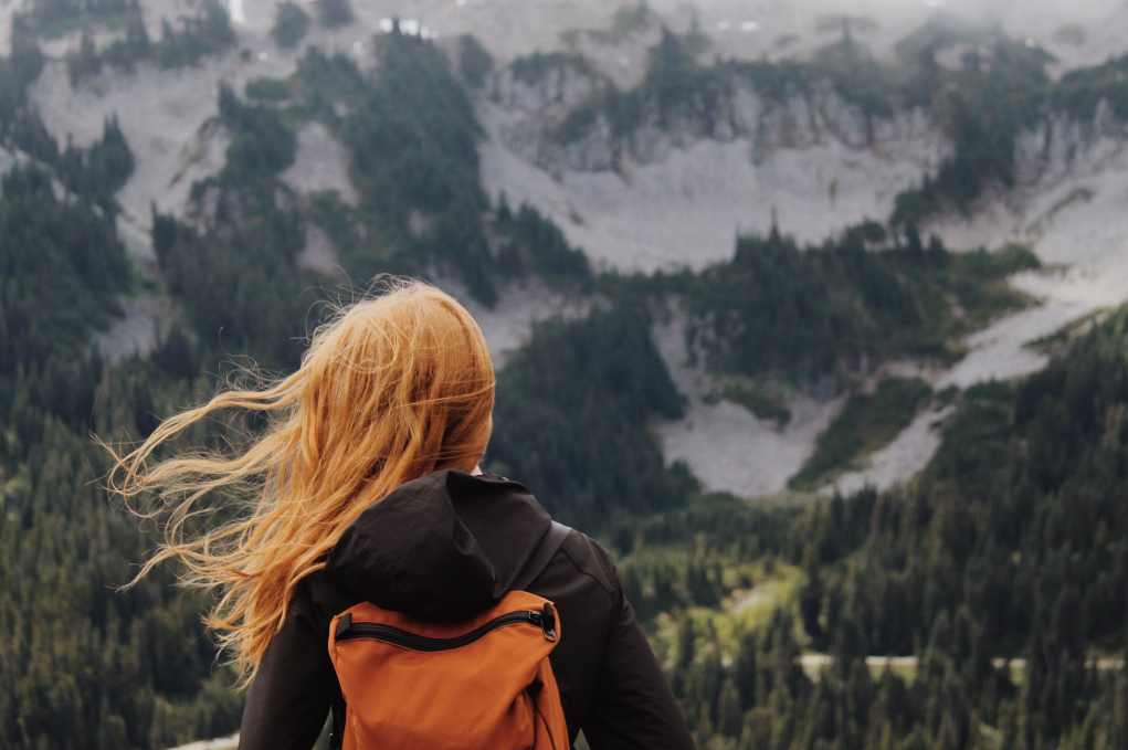 A woman looking at mountains.