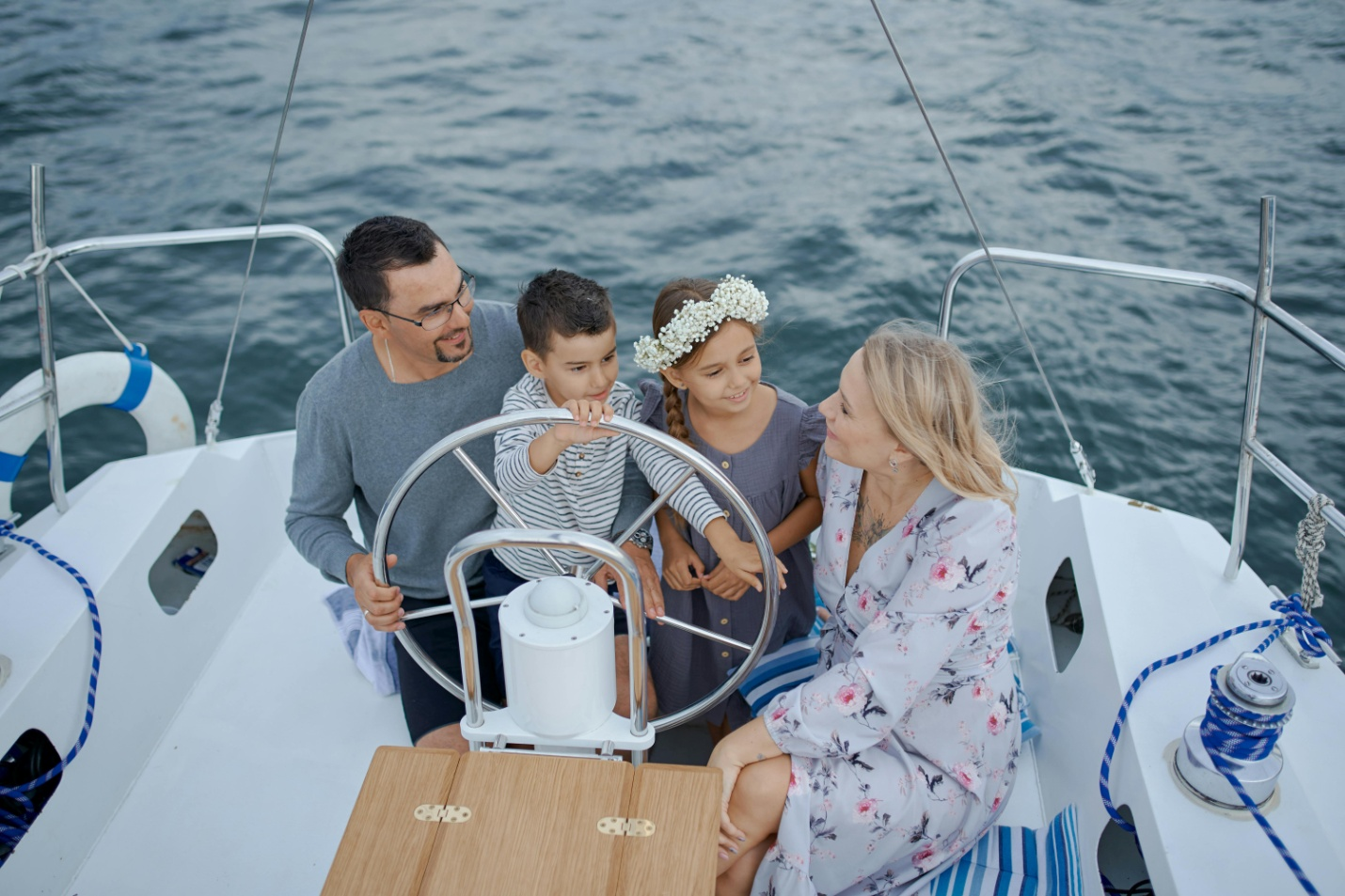 A happy family sailing through the sea on a yacht