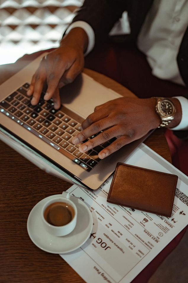 A person filling out an emergency passport renewal application on the laptop