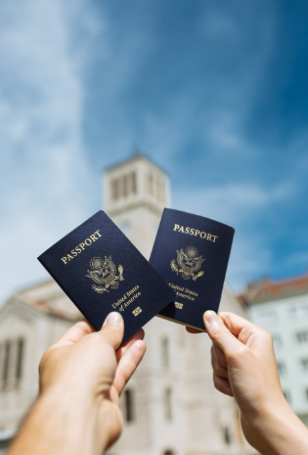 Two people holding their passports.