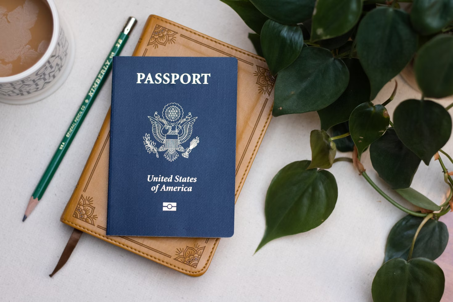 A passport on top of a table next to a cup of coffee