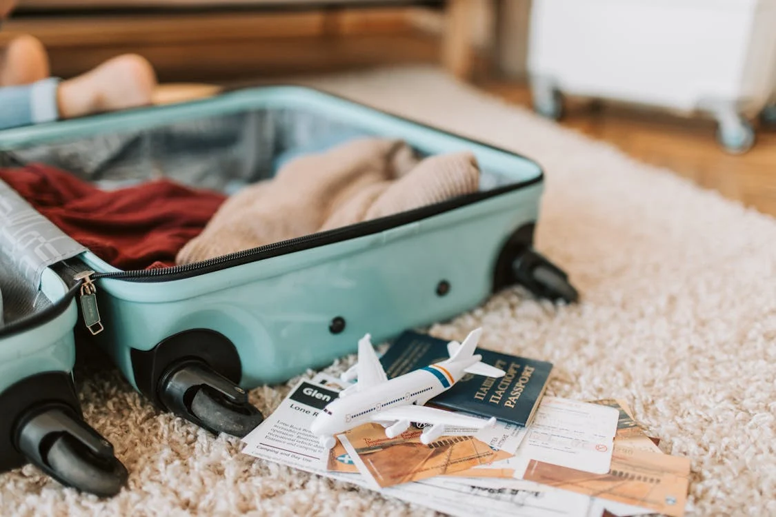 a green suitcase on a carpet